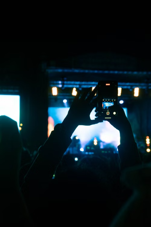 Recording video of live concert stage lit with gold and cyan lights