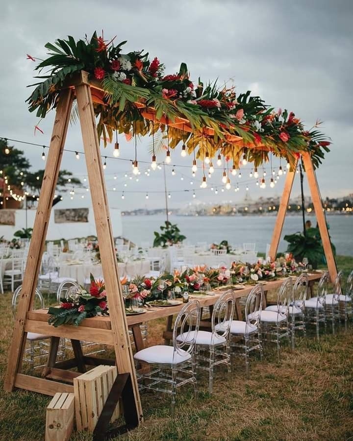 Outdoor venue setup with tropical florals and fairy lights